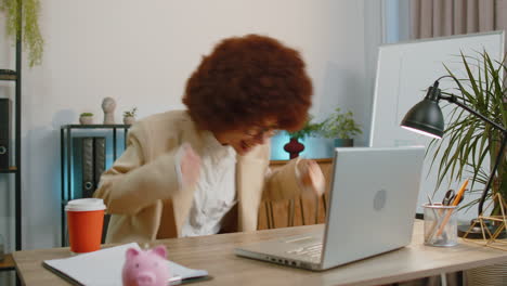 business woman winner working browsing typing on laptop at office celebrate lottery win good news