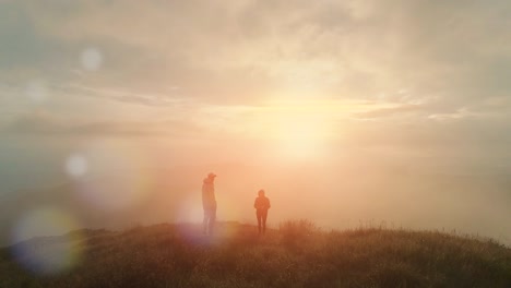 the man and woman meet the sunrise on the mountain top