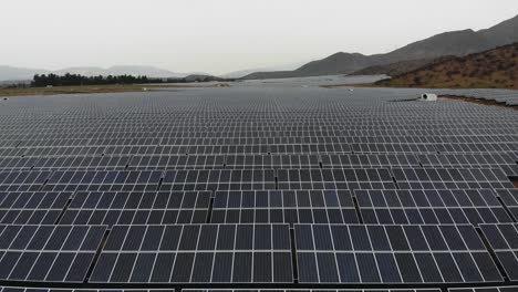 Aerial-Drone-Shot-over-giant-Photovoltaic-plant-on-a-cloudy-day,-Chile-4K