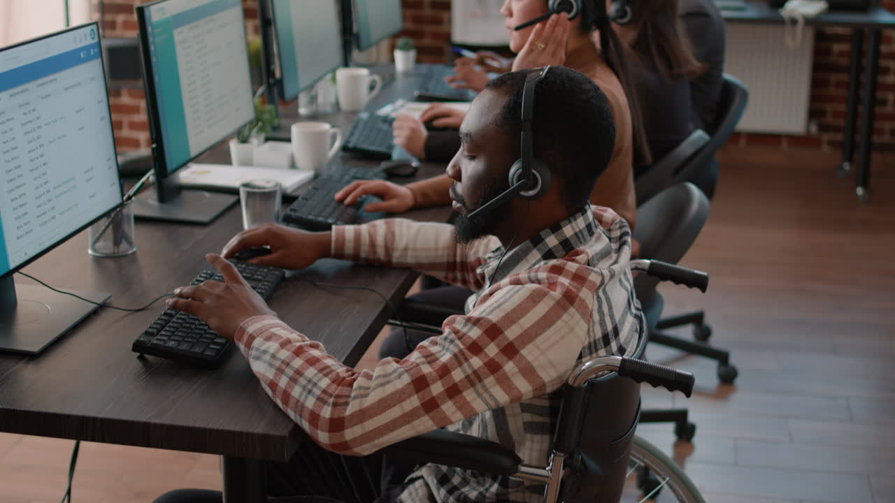 Office worker with handicap using headset to talk to clients