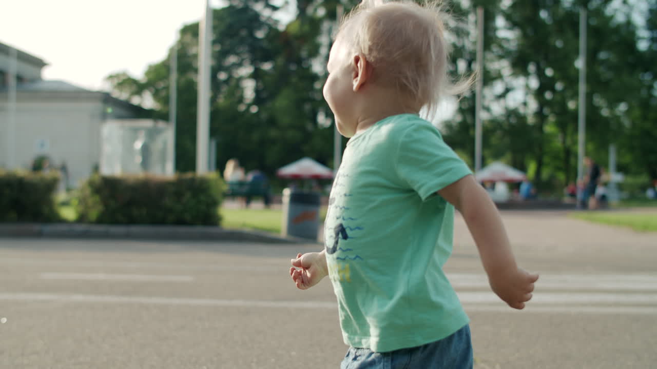 Happy boy going rapidly outdoors on road.