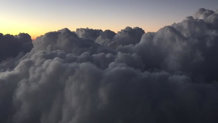 climbig through the clouds on the sunset