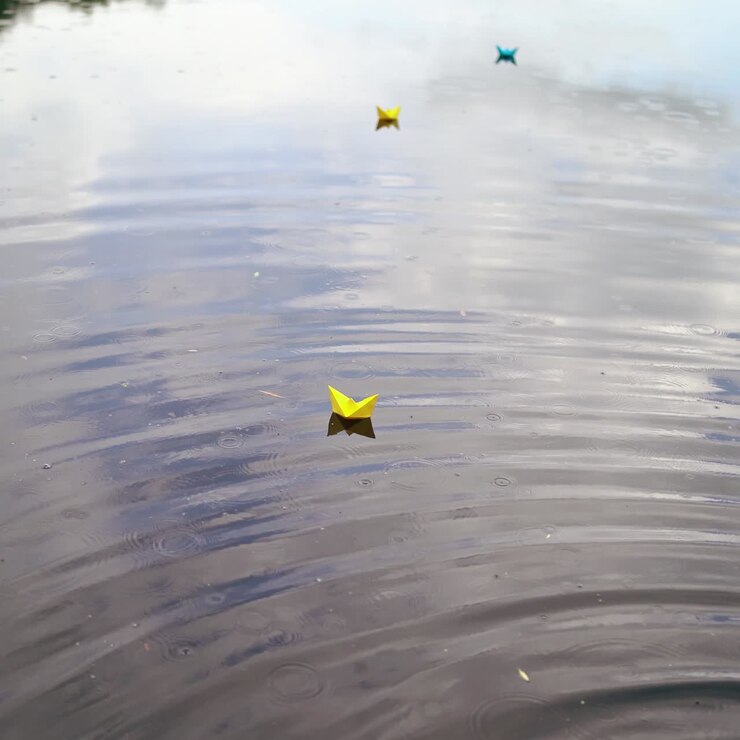 Paper boat sailing along river