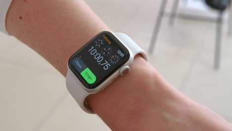 smartwatch. young woman using smart watch. closeup of female touching touch screen on watch entering watch app.