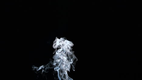 rising white smoke on black background