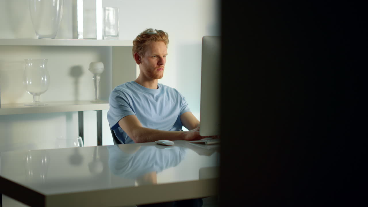 Office worker typing computer keyboard writing email at cozy remote workplace.