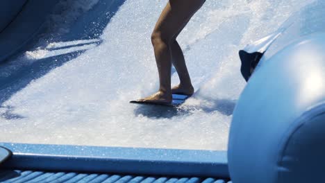 surfing wave machine slow motion, close up on feet