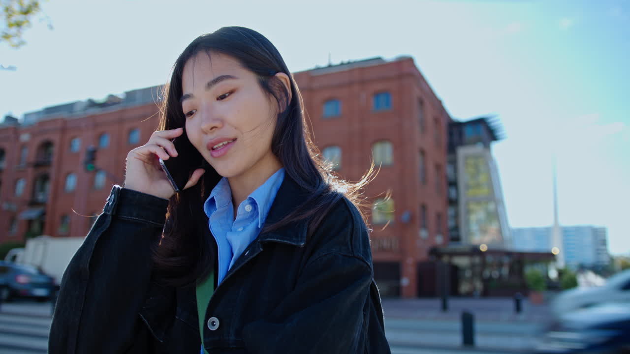 Young Asian Woman Having Phone Talk on the Street