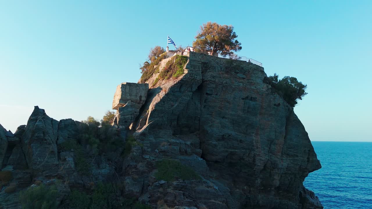 은 파란 하늘 아래 바다 위로 아오르는 초록색의 바위 절벽