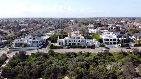 aerial - drone shot of luxury mansion on the beach, australia