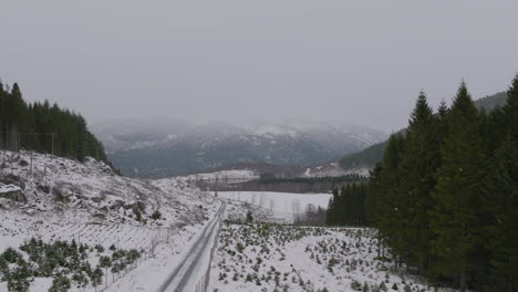 a cloudy scenic valley natural landscape covered in snow in the norwegian countryside