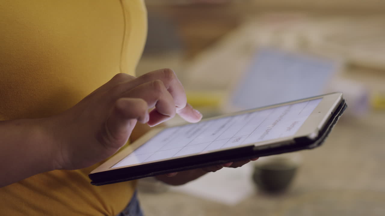 Woman using a tablet in a kitchen