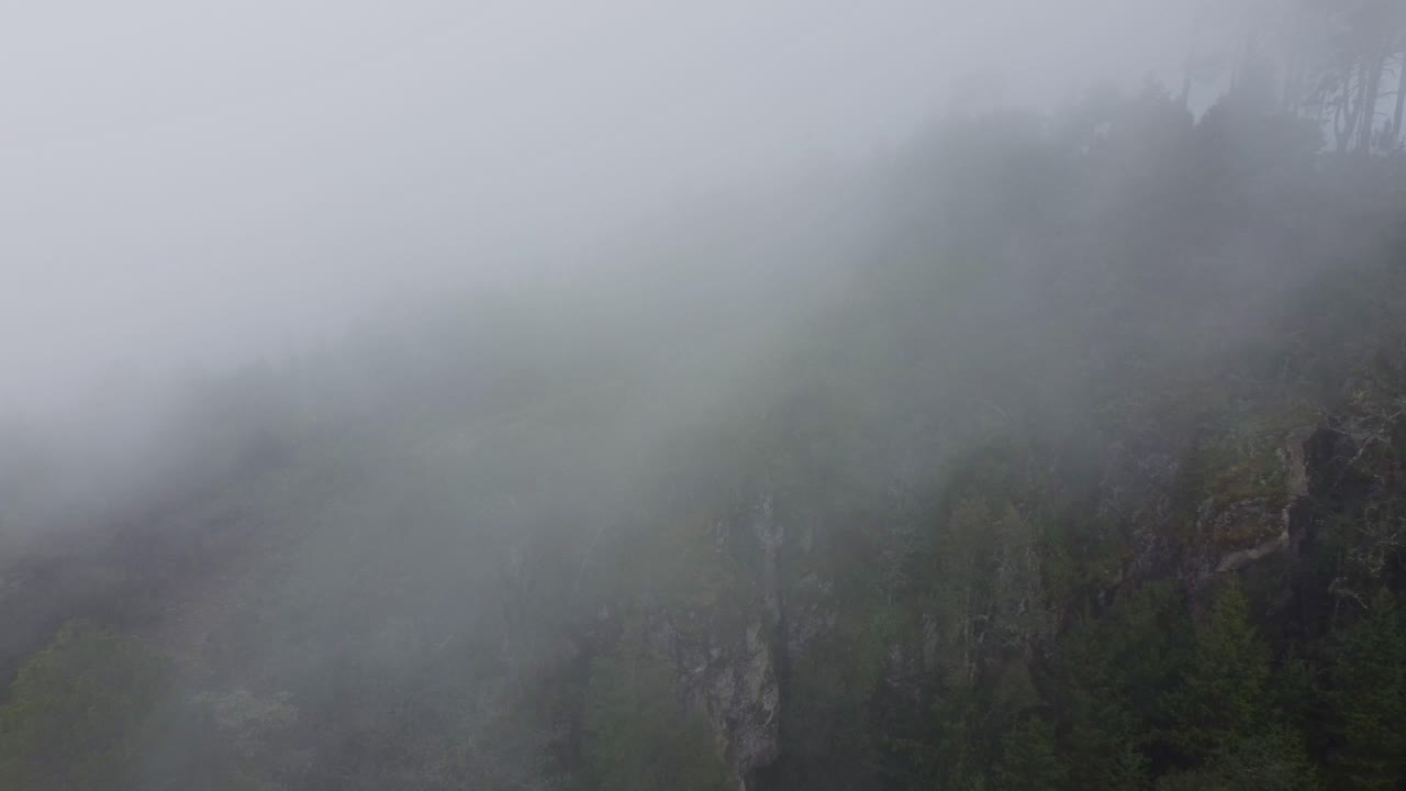 Just a guy running uphill on a beautiful and foggy mountain.