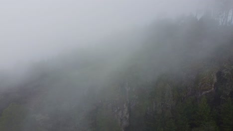 just a guy running uphill on a beautiful and foggy mountain.