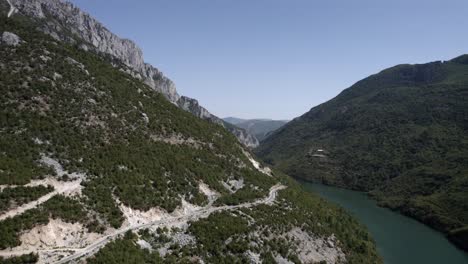 drone video of ascending crane plane revealing part of the drin river at valbona pass in kukes county