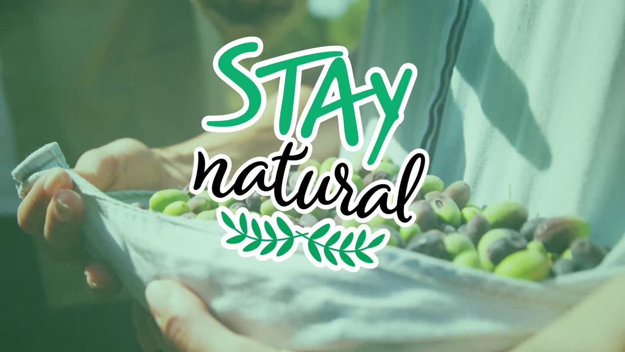 Animation of stay natural text over caucasian man picking fruit