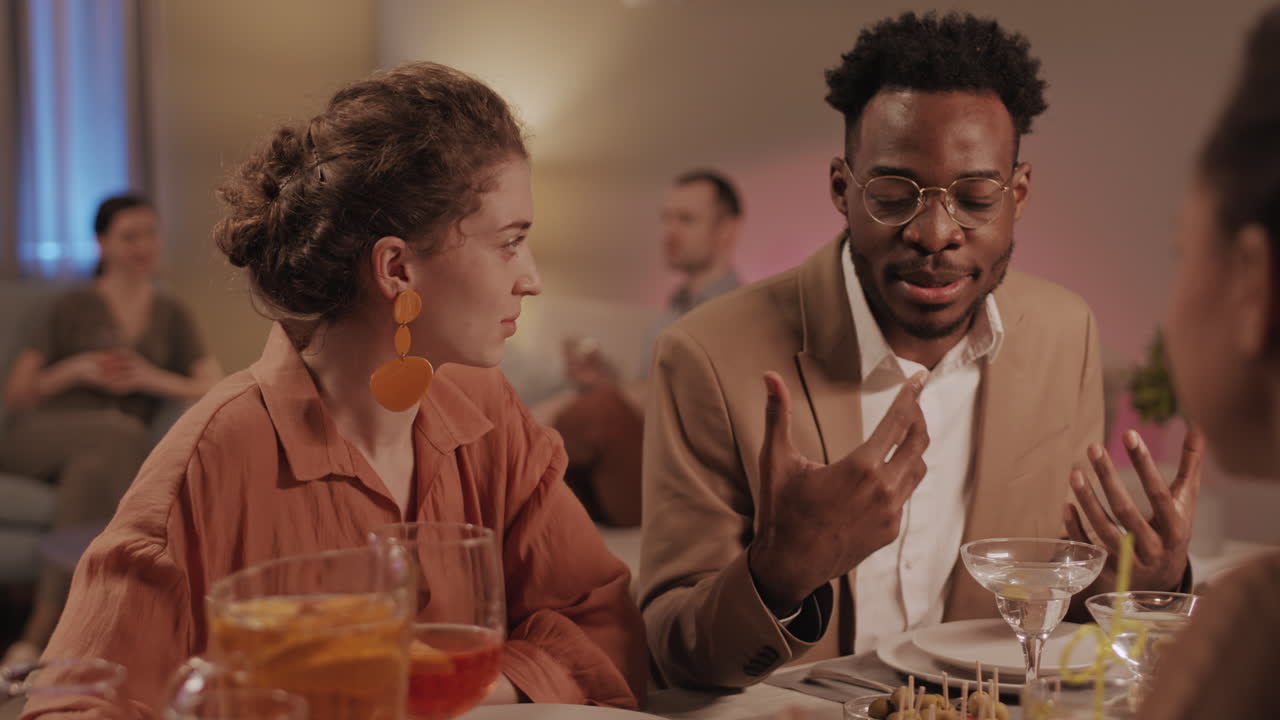 Afro American Man Talking at Friends Dinner Party