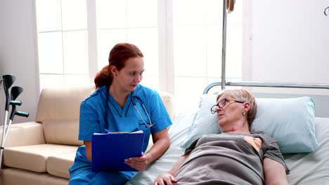 female nurse taking notes on clipboard in nursing home