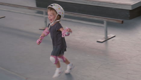 cute little girl running along skating park