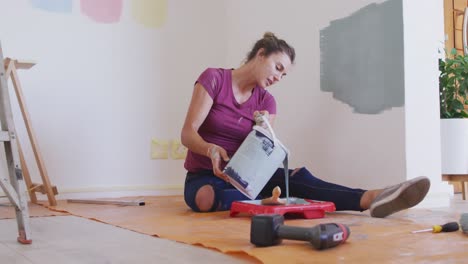 portrait of a caucasian woman in quarantine during coronavirus pandemic, doing interior work