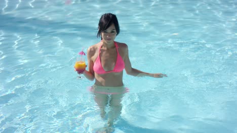 Young-woman-cooling-off-in-a-swimming-pool