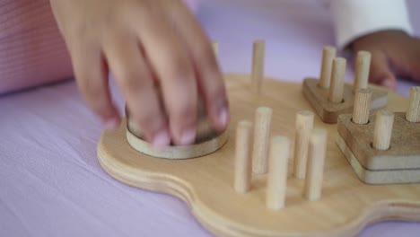 child playing with wooden puzzle