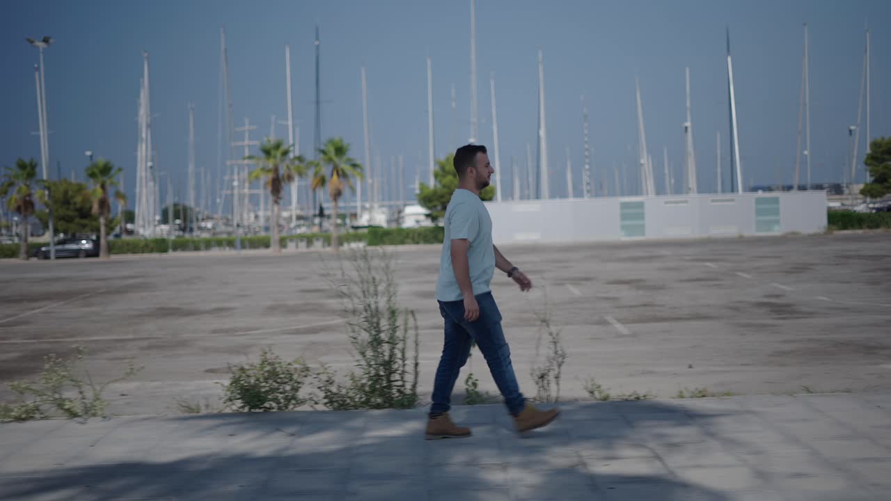 Man Walking in a City Marina