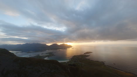 FPV-reveal-of-Rambergstranda-beach-on-a-golden-sunset-evening,-Lofoten-Islands-in-Norway,-impressive-close-flight