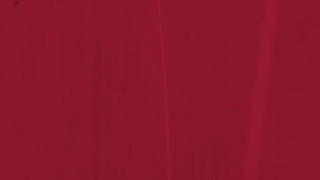 Texture grunge rosso scuro con schizzi ed effetto rumore.