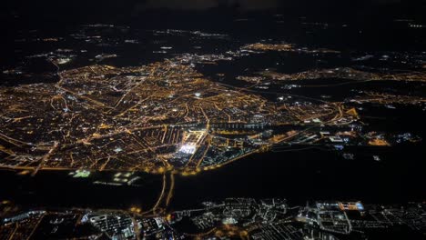 Aerial night view of the city of Seville iluminated for the April Fair taken from a jet cockpit