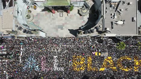 black lives matter street mural with large crowd