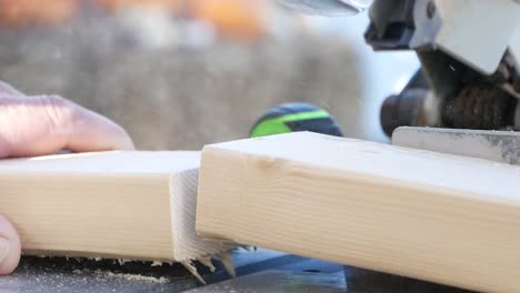 Plank-of-Wood-Being-Cut-on-Fixed-Metal-Machine-Circular-Saw,-Close-Up