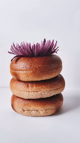 stack of bagels with purple flower