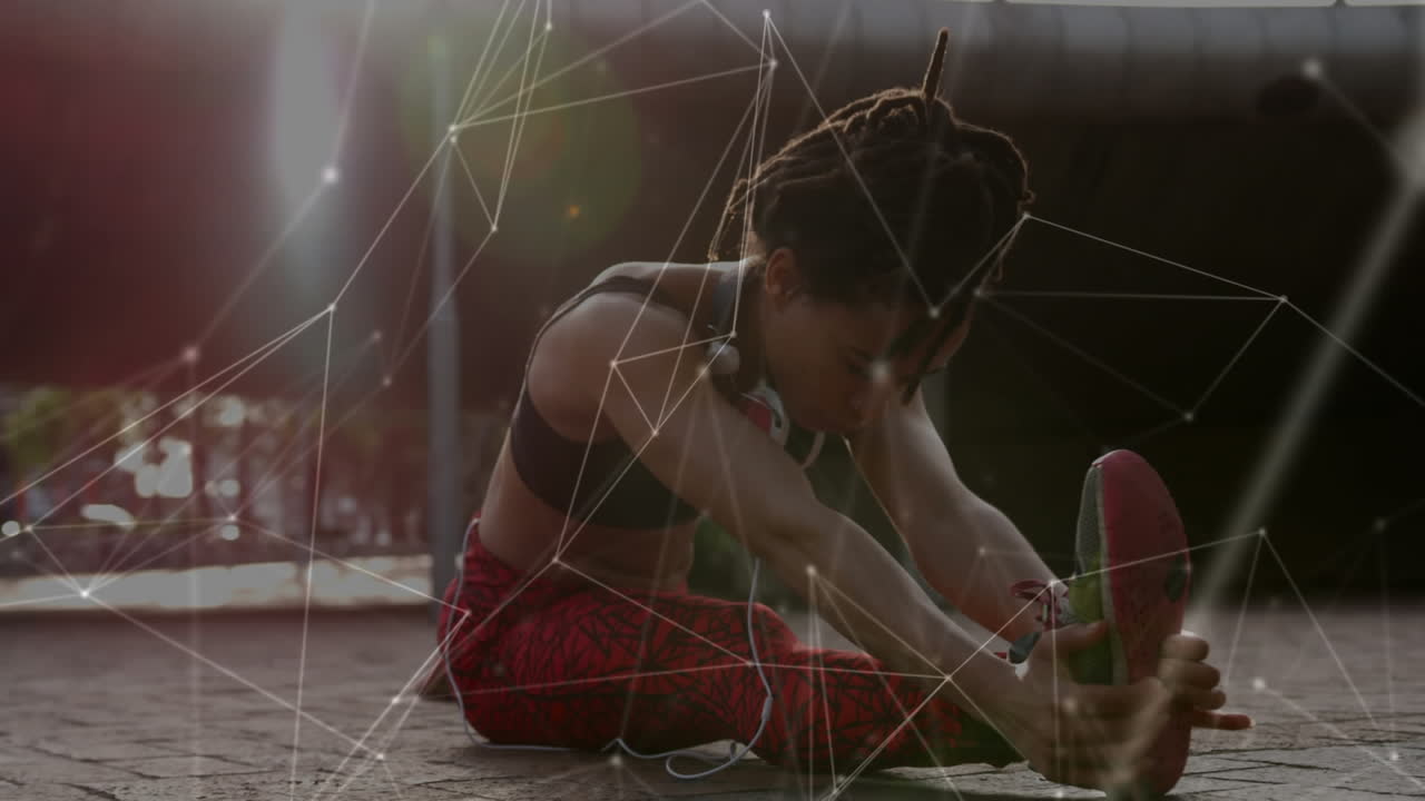 red de conexiones contra una mujer afroamericana que realiza ejercicios de estiramiento en el parque