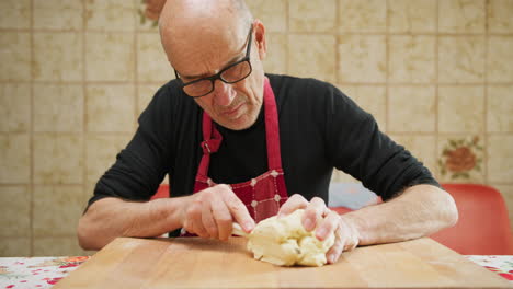 elderly man works hard in the morning to prepare pasta