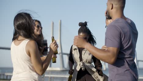 company of young people dancing with alcohol.