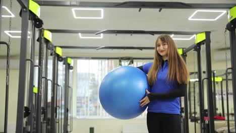 woman with exercise ball in gym