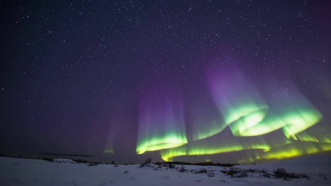 Northern Lights over a snowy landscape