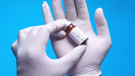 covid-19 vaccine vial in doctor's hands