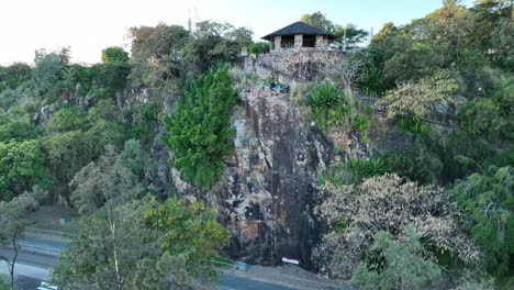 Drone-shot-of-Man-Descending-Brisbane's-Kangaroo-Point-Cliffs,-shot-at-sunrise