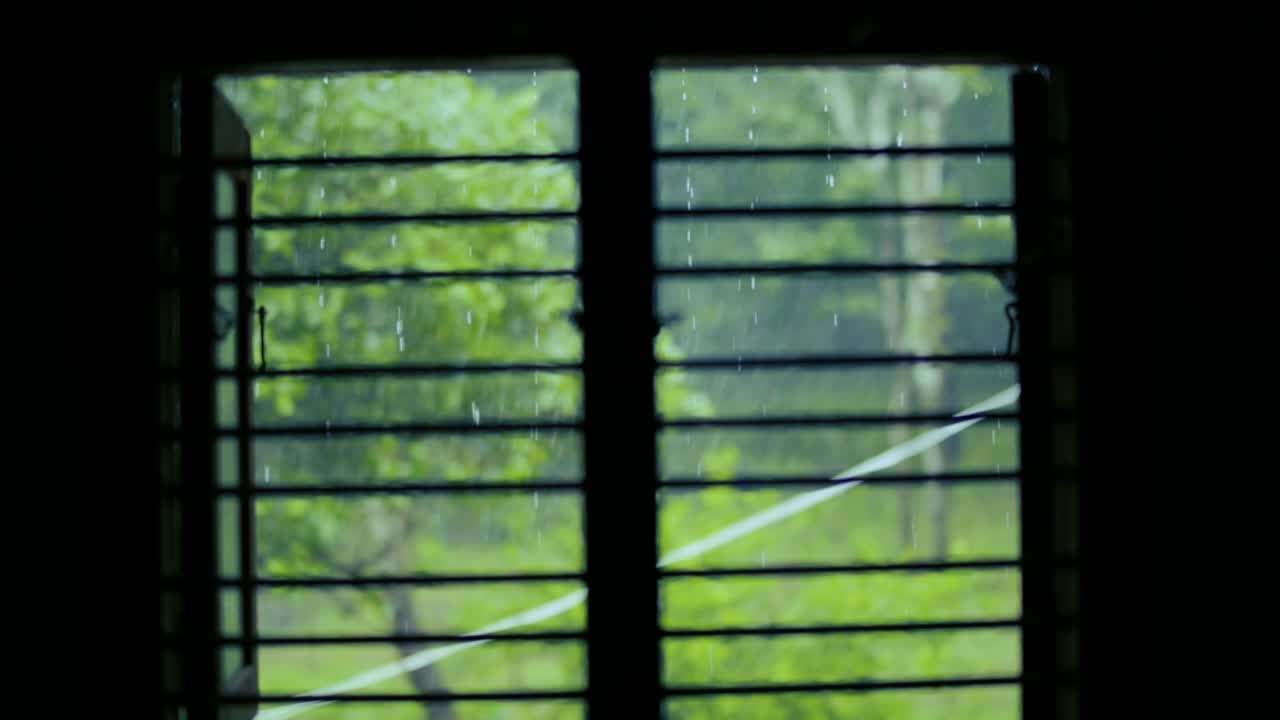 Watching storm through window. Static, soft focus