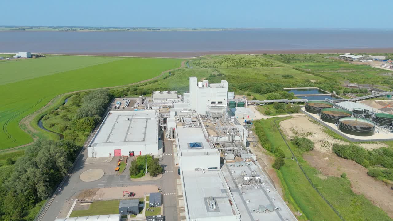 Overhead drone video of fibre making facility showing emissions and machinery in Grimsby
