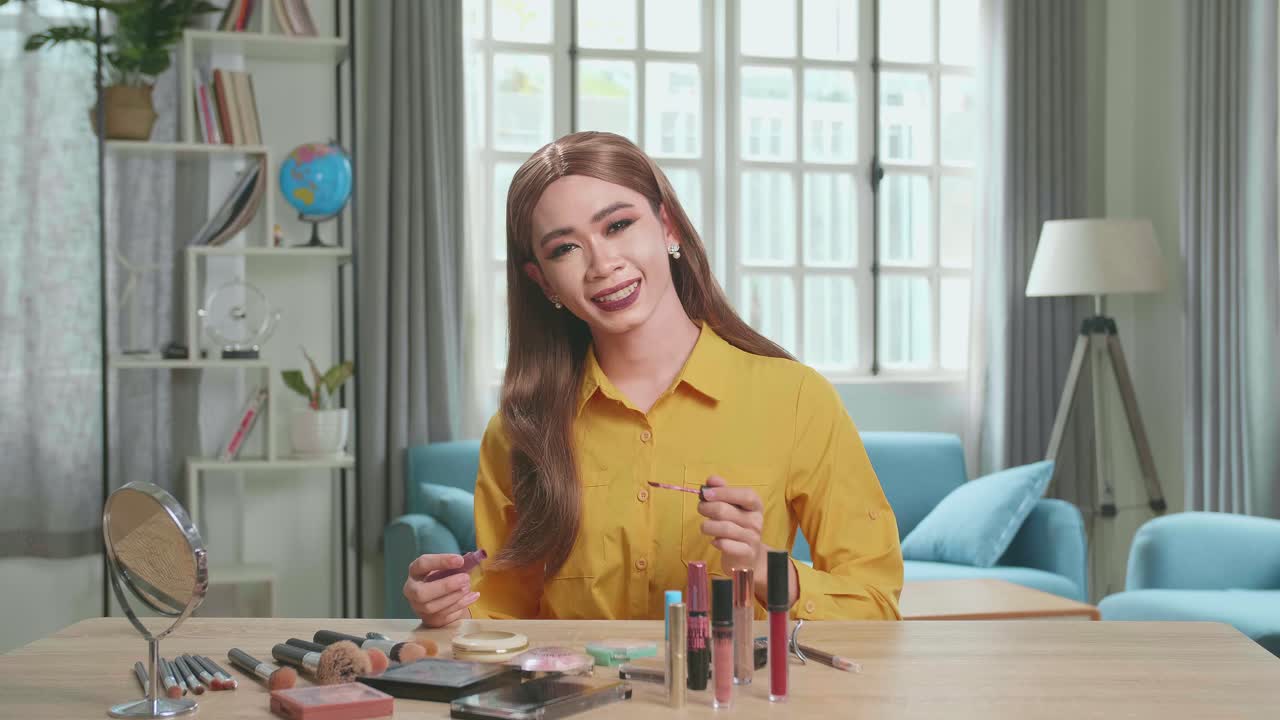 Influencer Young Transgender Woman Blogger Makeup. Transgender Woman Looks And Smiles To Camera In Home Studio