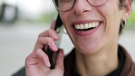 Cropped-shot-of-happy-woman-talking-by-smartphone