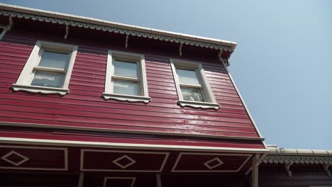 red wooden house with white trim