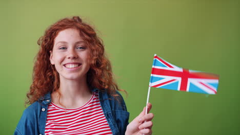 young woman holding british flag