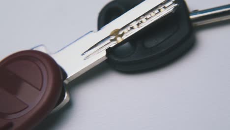 metal and magnetic keys lie on empty white surface macro