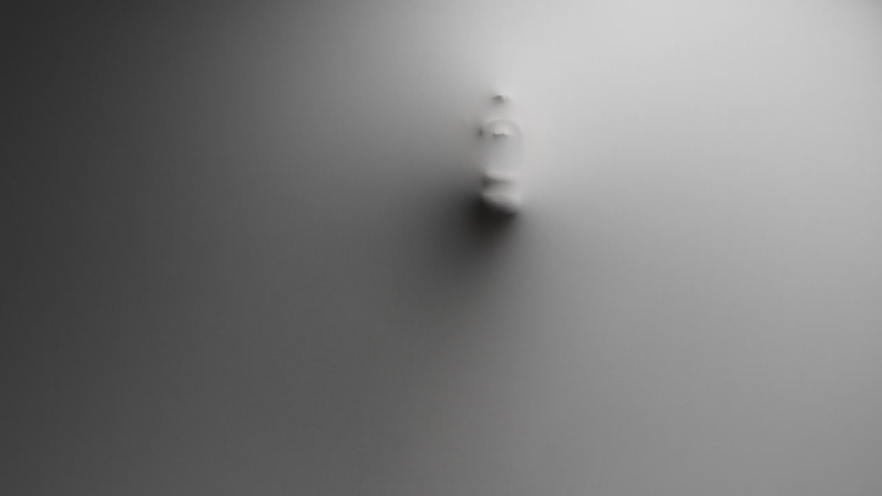 A scary silhouette of a woman appears screaming from the white wall