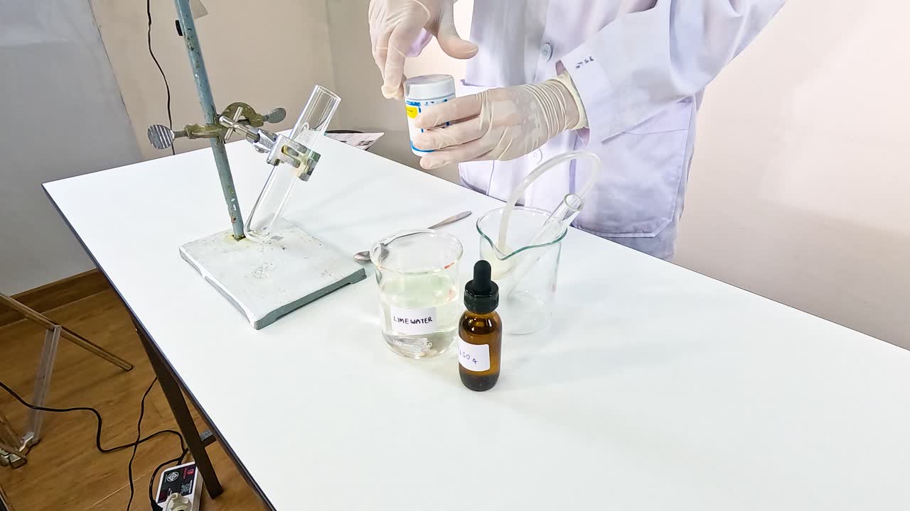 A scientist conducts a chemical reaction using copper carbonate and sulfuric acid in a lab setting with controlled lighting