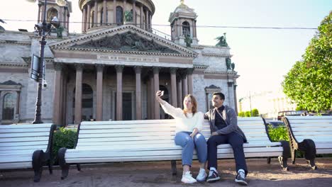 couple taking a selfie in front of a church